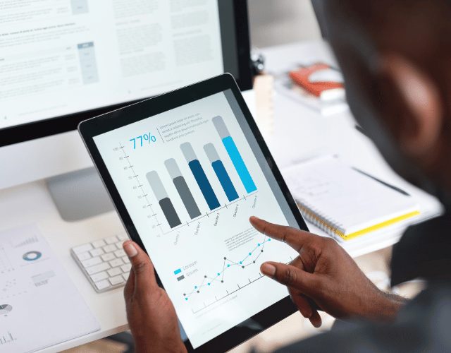 Male looking at graphs and charts on a tablet