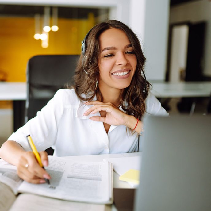 Young woman student wear wireless headphone whilst on a pre-retirement webinar