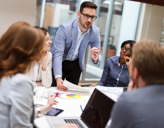 Man discussing plan and strategy with project team in an office
