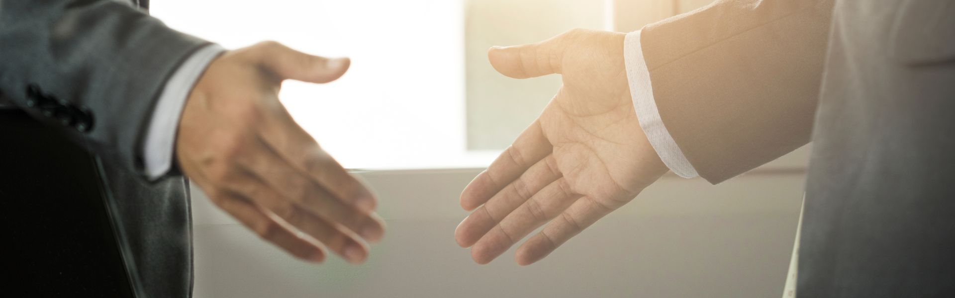 Supplier Information Banner - A close up of two people about to shake hands