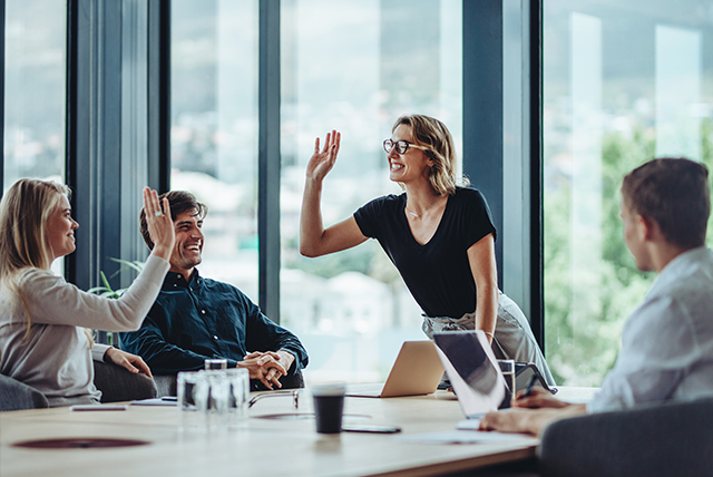 Corporate professionals celebrating success in meeting