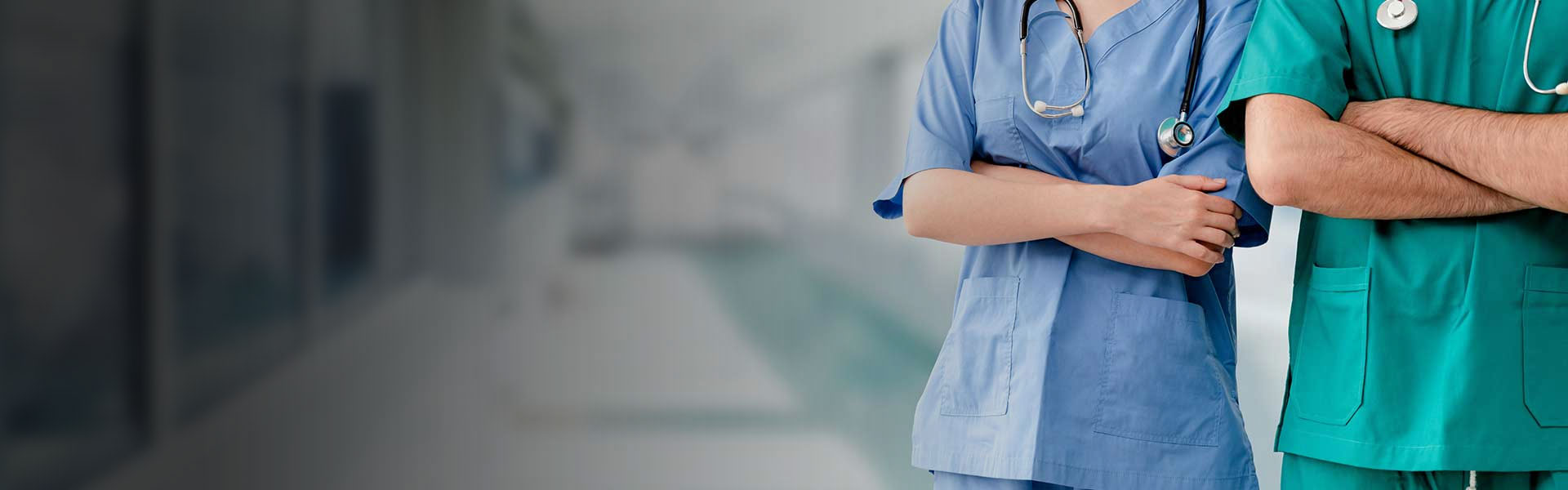 Two hospital staffs - surgeon, doctor or nurse standing with arms crossed in the hospital. Medical healthcare and doctor service.