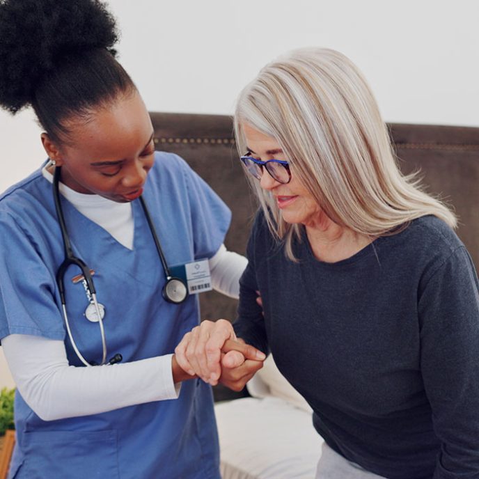 Walking, support and doctor with senior woman in homecare facility for medical home consultation. Balance, recovery and elderly female with a nurse in bedroom for therapy, help or healthcare advice