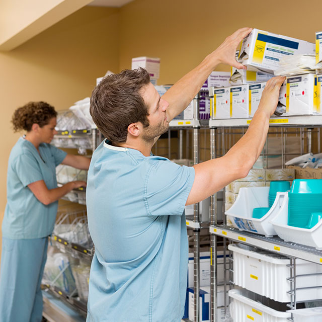 Nurses Arranging Stock In Storage Room after buying products through the new procurement system