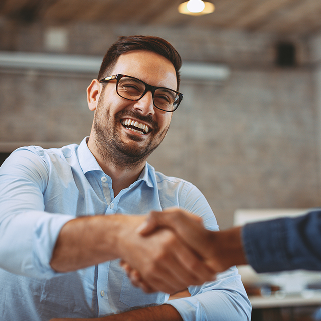 NHS Workforce Consultancy, two people shaking hands